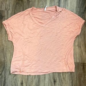 Soft light pink shirt.